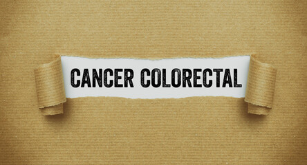 Torn paper revealing the word Colon cancer in french