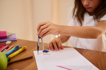 Student Drawing Circles with a Compass in Art and Math Class