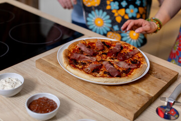 Indulge in a Delicious Homemade Pizza with a Variety of Toppings Arranged on a Wooden Board