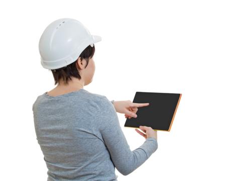 Rear view woman engineer wearing protective white helmet, using tablet gadget for work. Solving problems with the help of modern technology. Female architect isolated on transparent background - Powered by Adobe