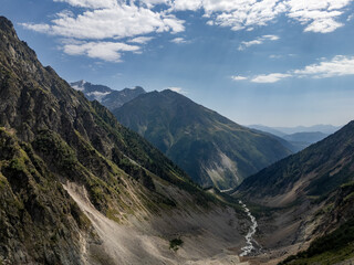 Breathtaking mountain valley landscape in Mestia, Svaneti, Georgia, showing a winding river flowing through steep slopes