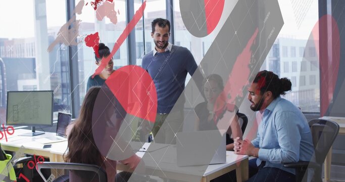Five team members reviewing digital charts and leaning over desk in office meeting, with laptops - Powered by Adobe