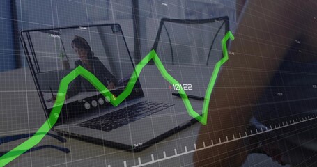 Two laptops showing call interface and hand typing in home office, with blue pen, chart overlay