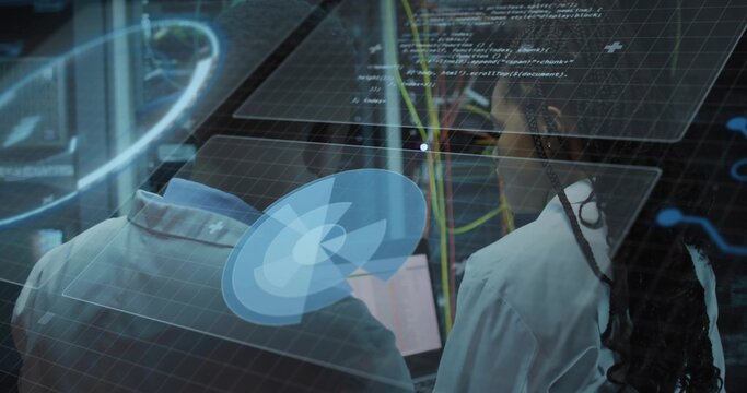 Analyzing virtual interface, two technicians in lab coats adjusting network cables in data center