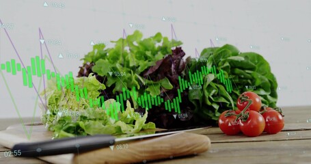 Displaying knife and lettuce on cutting board in kitchen, with cherry tomatoes and financial charts