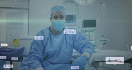 Sitting surgeon in scrubs monitoring vital signs on screens in OR, with digital overlay icons