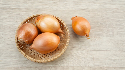 Fresh onion on bamboo plate