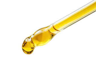 Fototapeta premium Close up of a pipette with a drop of yellow oil isolated on transparent background
