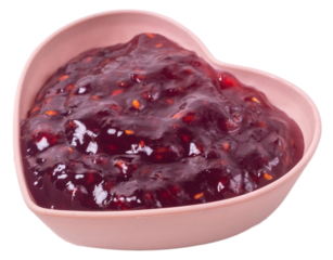 Isolated raspberry jam in a heart shaped rosette on a white background, side view
