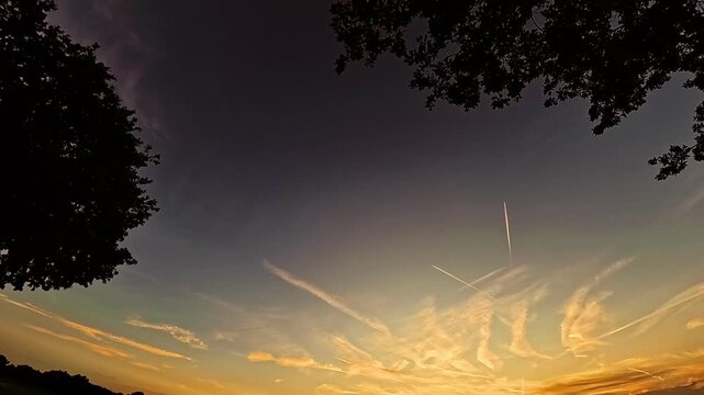 4K Timelapse video with moving clouds and landing and starting airplanes near sunset or sundowner at MUC airport, Munich, Bavaria, Germany