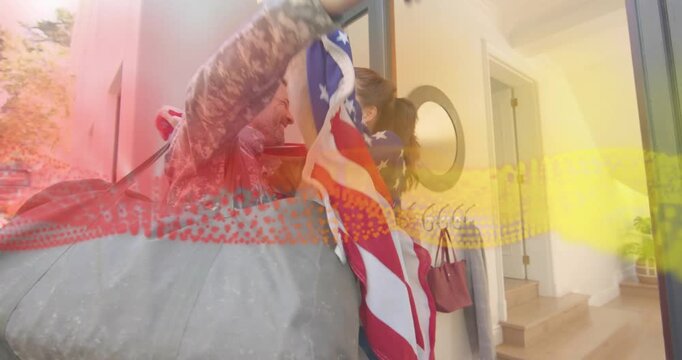Returning military soldier arriving door, spouse draping flag and hugging homecoming in entryway