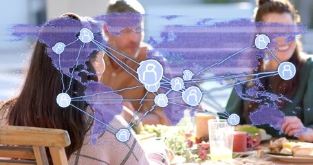 Friends gathering around patio table while network overlay animating at start for technology demo - Powered by Adobe