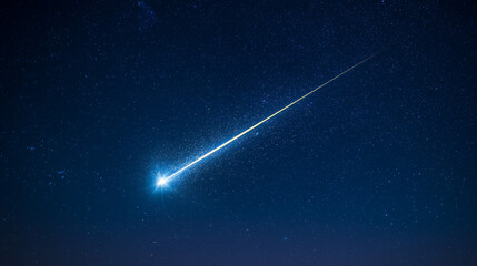 A brilliant meteor streak with a glowing tail in a star-filled night sky.