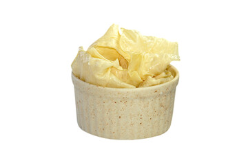 Tofu sheets in a cup placed on a white background.