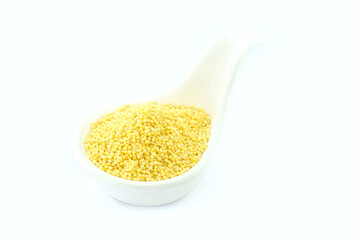 Millet in a White spoon-shaped cup on a white background.