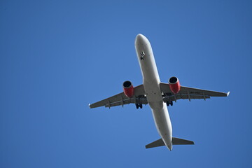 Passenger airplane in blue sky seen from below
