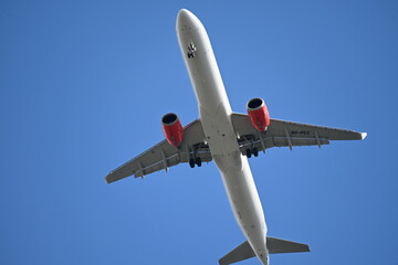 Passenger airplane in blue sky seen from below
