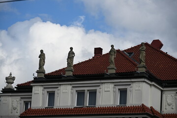 Statues of women by the vaulted roof of a beautiful building
