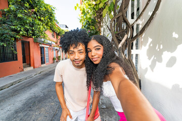 Gen Z friends taking a selfie outdoors on a sunny day