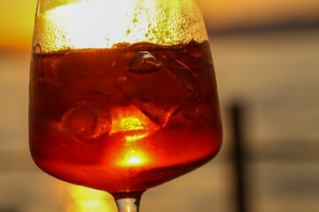 sunset aperitif in bardolino, refreshing drink with ice and citrus slice