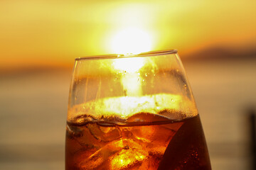 sunset aperitif in bardolino, refreshing drink with ice and citrus slice