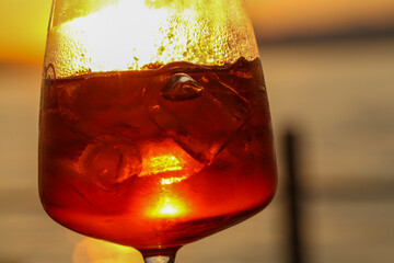sunset aperitif in bardolino, refreshing drink with ice and citrus slice