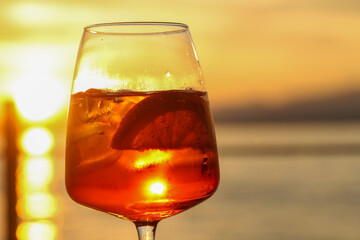 sunset aperitif in bardolino, refreshing drink with ice and citrus slice