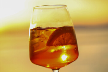 sunset aperitif in bardolino, refreshing drink with ice and citrus slice