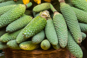 Delicious exotic fruits of Monstera deliciosa (banana pineapple, banana ananas or ceriman) on traditional farmer market in Funchal, Madeira, Portugal