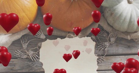 Red 3D hearts appearing, floating and swirling then dispersing, revealing pumpkins and parchment - Powered by Adobe