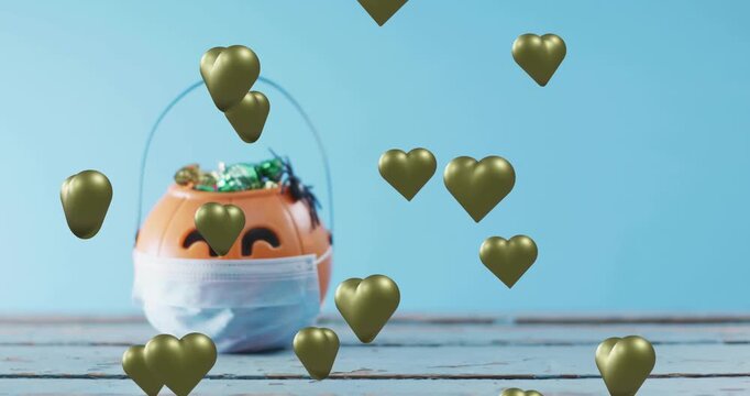 Hearts spawning at top and drifting down around pumpkin bucket wearing mask candy-filled decoration