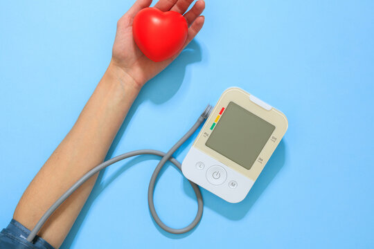 Top view of arm with heart shape and blood pressure monitor