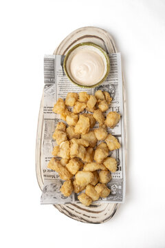Crispy marinated dogfish with dipping sauce on plate