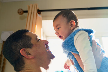Deaf father bonding with his joyful baby son