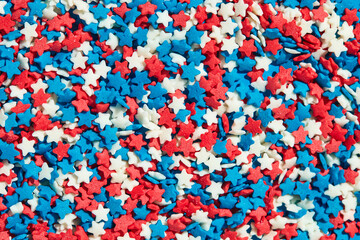 Colorful star shaped baking sugar sprinkles background