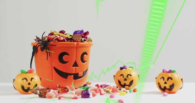 After pause neon-green line graph animating upward across pumpkin bucket showing candy sales trend