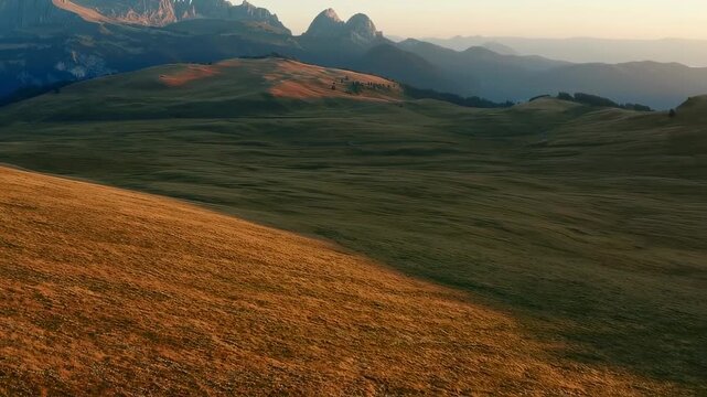 Mountain landscape with grassy slope and clouds