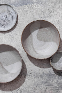 Minimalistic ceramic bowls on textured surface