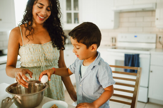 Mother and son cooking together in the kitchen