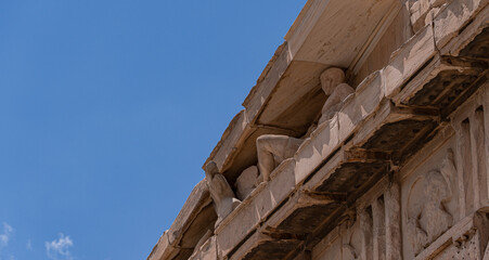 Ancient stone carvings at Acropolis with blue sky