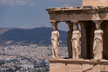 Classical statues on the Acropolis with cityscape view