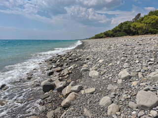 scenic deserted view of the seashore with pebbles