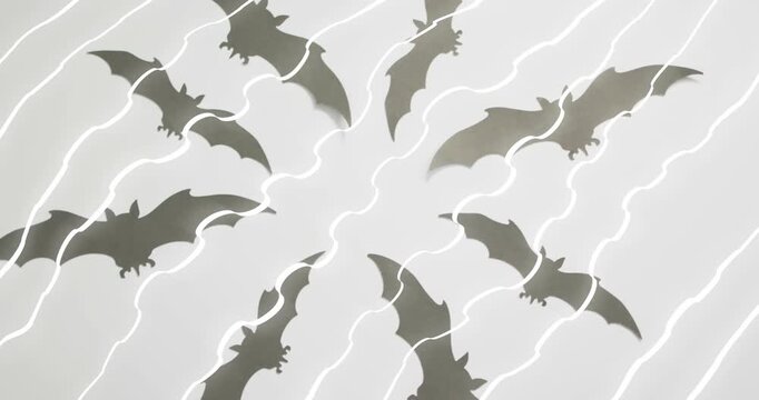 At start glowing white lines pulsing, weaving through rotating circle of bats showing energy flow
