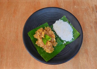 chicken and rice ,Sawut or Pasrah or Gobet served with steamed grated coconut,Indonesia traditional food from Yogyakarta.Made from steamed grated cassava mixed with brown sugar sauce