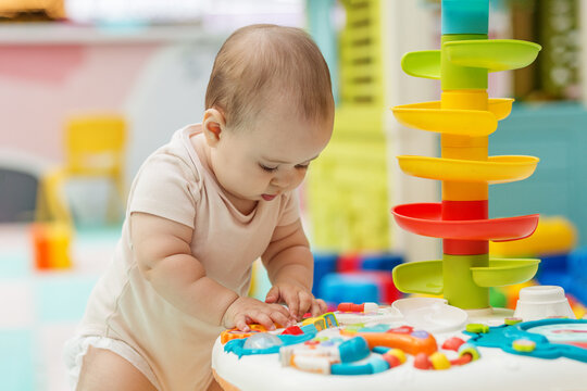 Baby exploring sensory toy table for development learning
