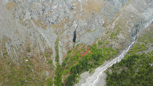 Aerial view of Ak-Sai Waterfall cascading down rocky cliffs in Ala Archa National Park, Kyrgyzstan.