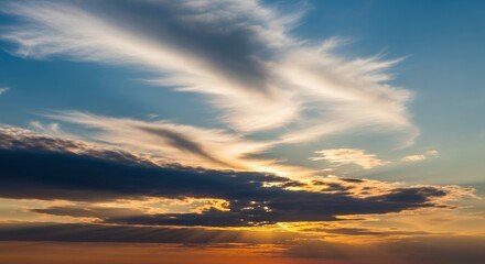 Obraz premium Dramatic sunset/sunrise sky with vibrant clouds and sun rays breaking through.