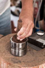 jeweler shaping silver in the workshop