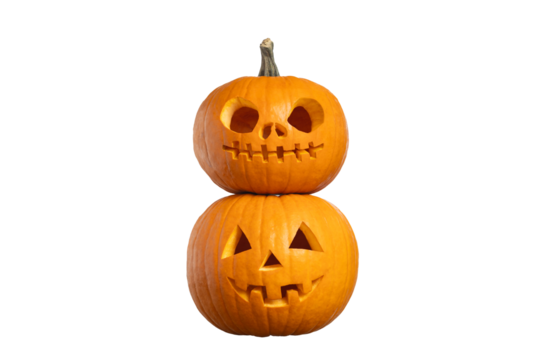 Two stacked carved Halloween pumpkins jack o’lanterns isolated on white background, spooky holiday decoration with copy space