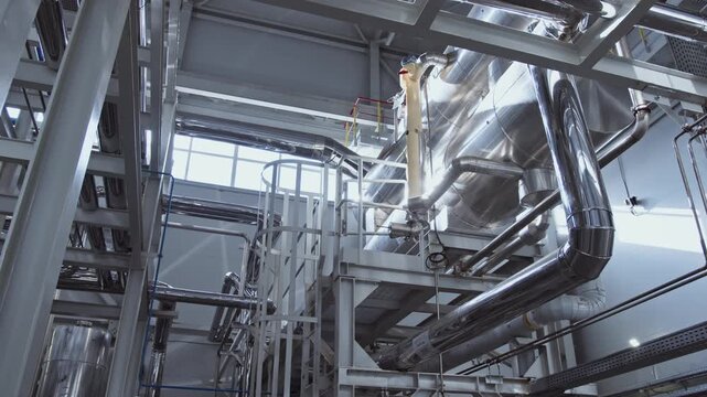 Chrome-plated clean shiny pipes in the factory. A pipeline at a chemical plant.